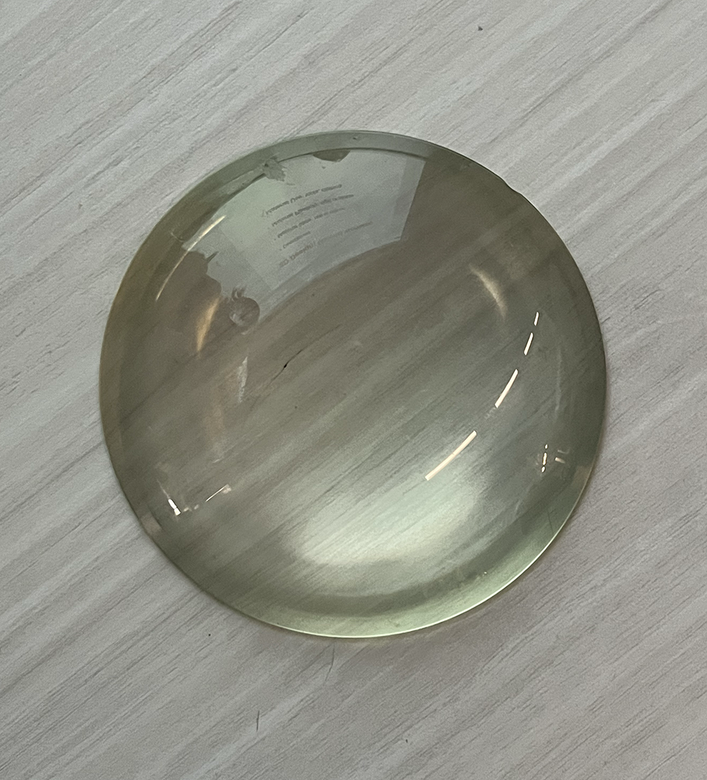 Glass is smooth, hard, fragile, and trasparent. When you touch it you will feel slippery, usually used for cups or windows.