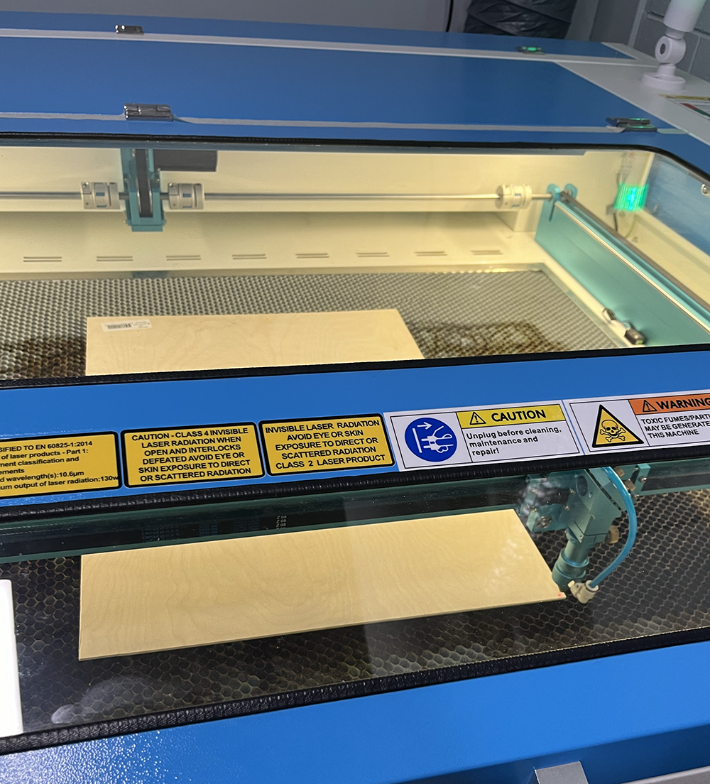 Laser cutting using machine on wooden board